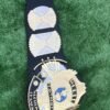 Close view of premium black leather strap on WWF Winged Eagle championship belt. Features hand-tooled pattern, snap fasteners on both ends, and flexible material for easy wear. Available in genuine or PU leather options.