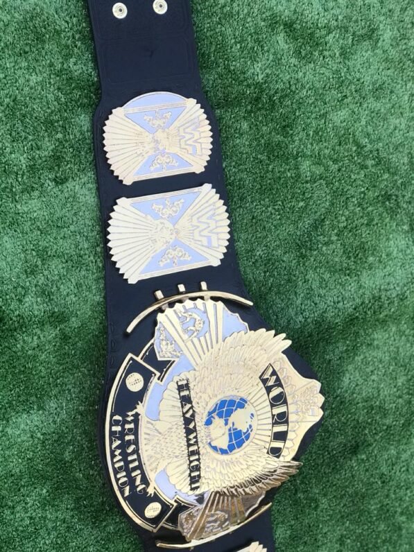 Close view of premium black leather strap on WWF Winged Eagle championship belt. Features hand-tooled pattern, snap fasteners on both ends, and flexible material for easy wear. Available in genuine or PU leather options.