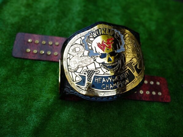 Front view of WWF Smoking Skull Championship Belt showing central skull plate with smoke effects, gold finish, and black leather strap