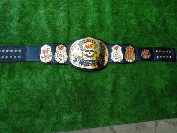 WWF Smoking Skull Championship Belt displayed flat showing full 52-inch length with all plates and complete strap