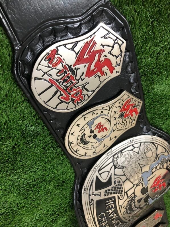 Close-up of WWF Smoking Skull Belt silver side plates with double etching and championship engravings