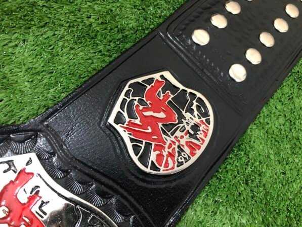 Close-up of black leather strap with dual snap closures and tooling pattern detail