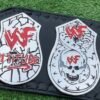 Close-up of WWF Smoking Skull Belt silver side plates with double etching and championship engravings
