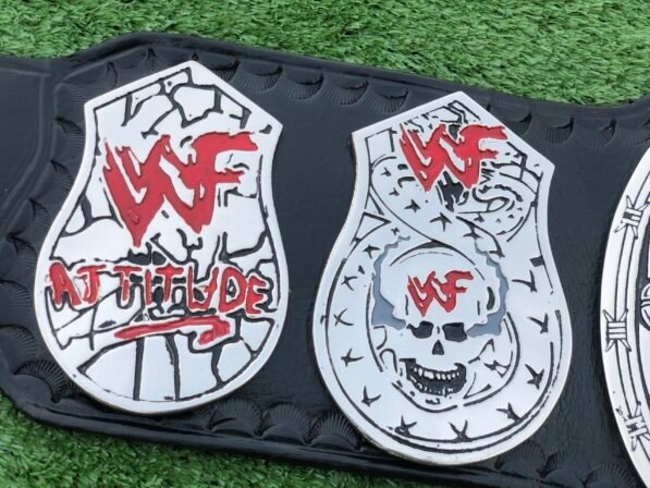 Close-up of WWF Smoking Skull Belt silver side plates with double etching and championship engravings