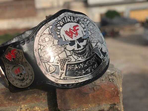 Front view of WWF Smoking Skull Championship Belt with 4mm silver zinc plates, black leather strap, and skull centerpiece design