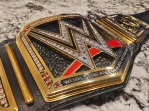 Close-up of WWE World Heavyweight replica belt 16MM CNC center plate with 24K gold plating cubic zirconia stones and deep etching
