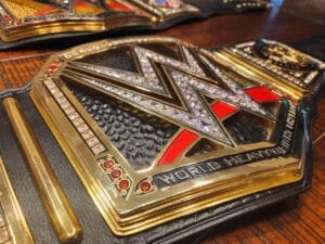 Close-up of WWE World Heavyweight replica belt 16MM CNC center plate with 24K gold plating cubic zirconia stones and deep etching