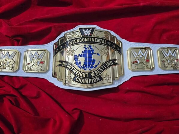 WWE Intercontinental Championship Belt full layout showing complete 50-inch length with center plate, side plates, leather strap, and gold plating