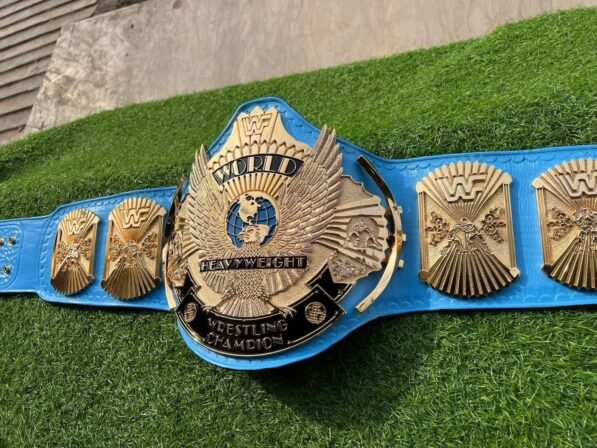 WWF Winged Eagle Championship Belt side profile showing 4mm blue leather strap thickness, CNC zinc plate depth, and snap fasteners