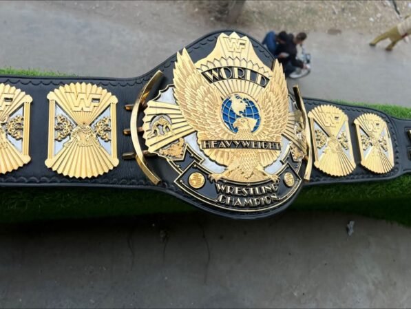WWF winged eagle championship belt black painted background showing stunning contrast and depth