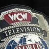 Close-up of WCW Television Championship Belt center plate showing deep CNC engraving and gold plating detail