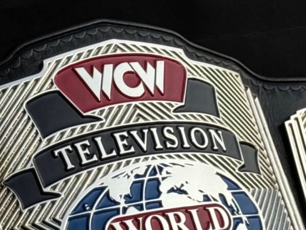 Close-up of WCW Television Championship Belt center plate showing deep CNC engraving and gold plating detail