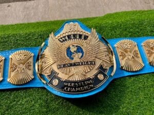 WWF Winged Eagle Championship Belt replica front view showing winged eagle center buckle with gold plating, 4mm CNC zinc, and blue leather