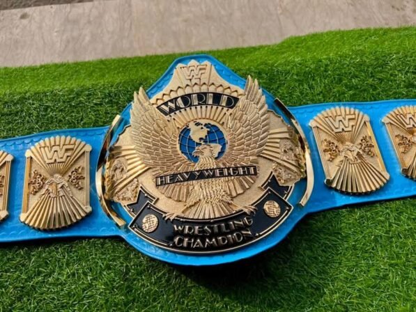 WWF Winged Eagle Championship Belt replica front view showing winged eagle center buckle with gold plating, 4mm CNC zinc, and blue leather