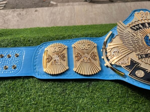 WWF Winged Eagle Championship Belt strap view showing 4mm blue genuine leather texture, snap fasteners, and 50-inch length detail