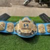 WWF Winged Eagle Championship Belt replica full layout showing complete 50-inch length with winged eagle plate, side plates, blue leather, CNC details