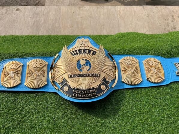 WWF Winged Eagle Championship Belt full layout showing complete 50-inch length with winged eagle plate, side plates, blue leather, CNC details