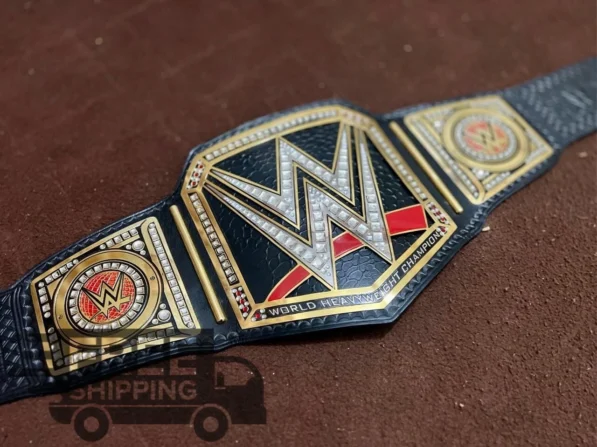 WWE World Heavyweight Championship Belt full layout showing complete 46-inch length with center plate, side plates, genuine leather strap, and gold finish