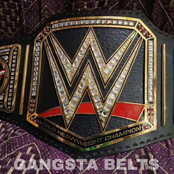 Close-up detail of WWE American Nightmare Championship Belt brass engraving, gold finish texture, and craftsmanship quality