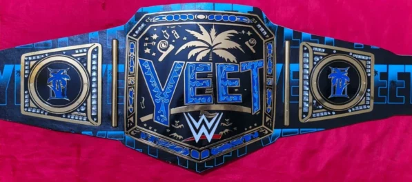 Close-up detail of YEET Belt showing 2mm brass plate engraving, gold finish texture, leather stitching, and Jey Uso championship quality
