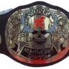 Close-up detail of Stone Cold Smoking Skull Belt showing 2mm brass skull engraving, silver finish texture, leather stitching, and WWE championship quality