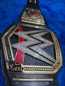 Black leather strap of WWE World Heavyweight Championship replica belt with snap button fasteners by Absolute Belts
